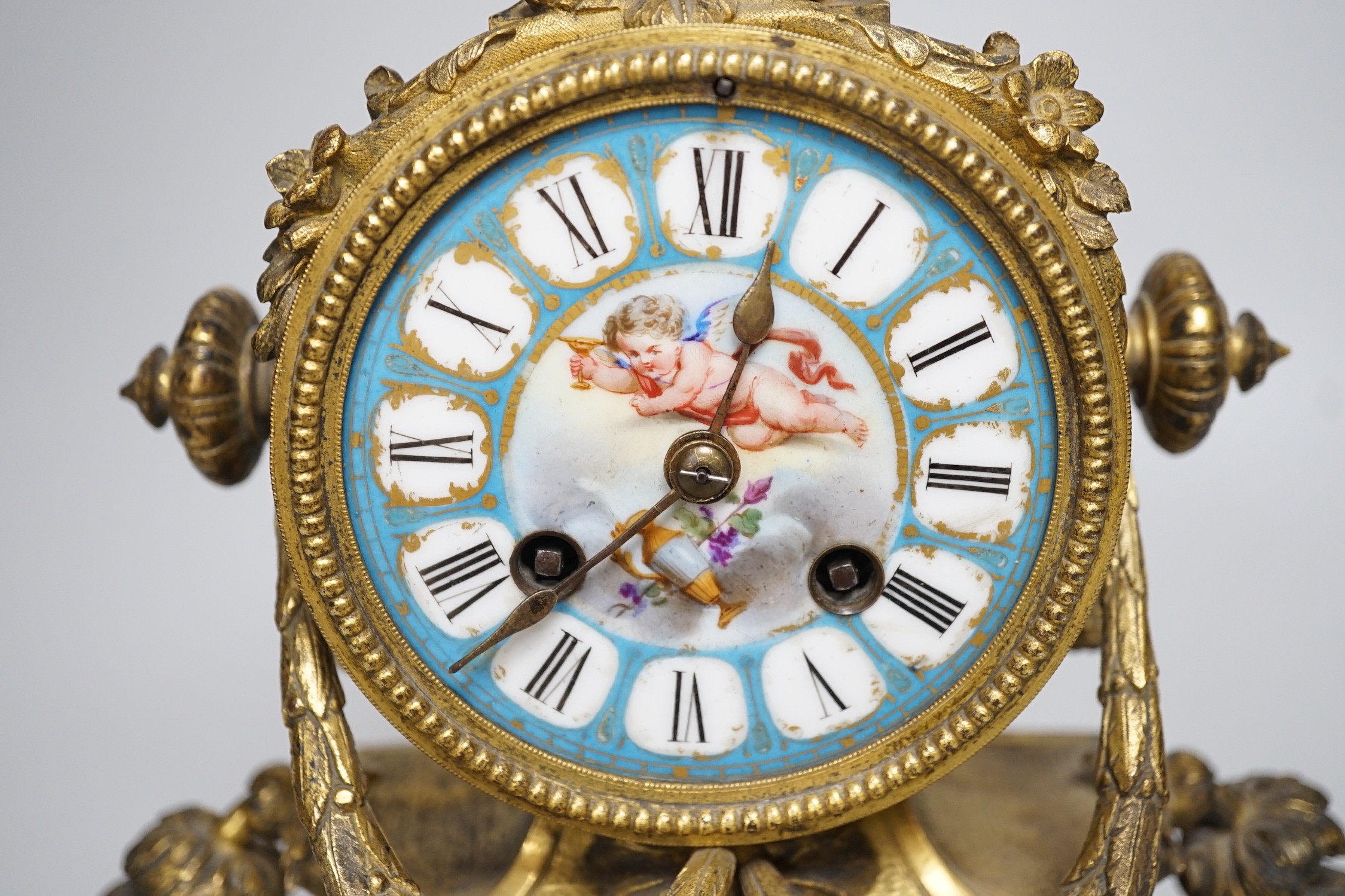 A 19th century French gilt-brass mantel clock with Sevres-style panels, 33cm